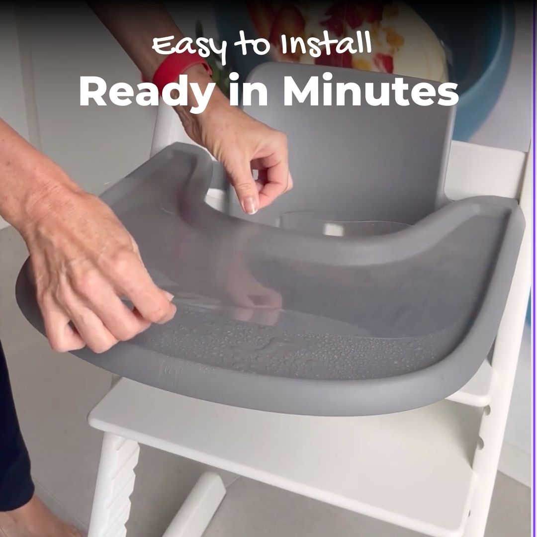 Women hands installing a suction sticker on a Stokke Tripp Trapp tray with water application method..