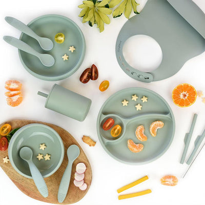 Brightberry Kids Tableware Dinner Bundle in Sage green showing a bowl, two silicone plates, bib, straw cup and silicone straws on the flatlay