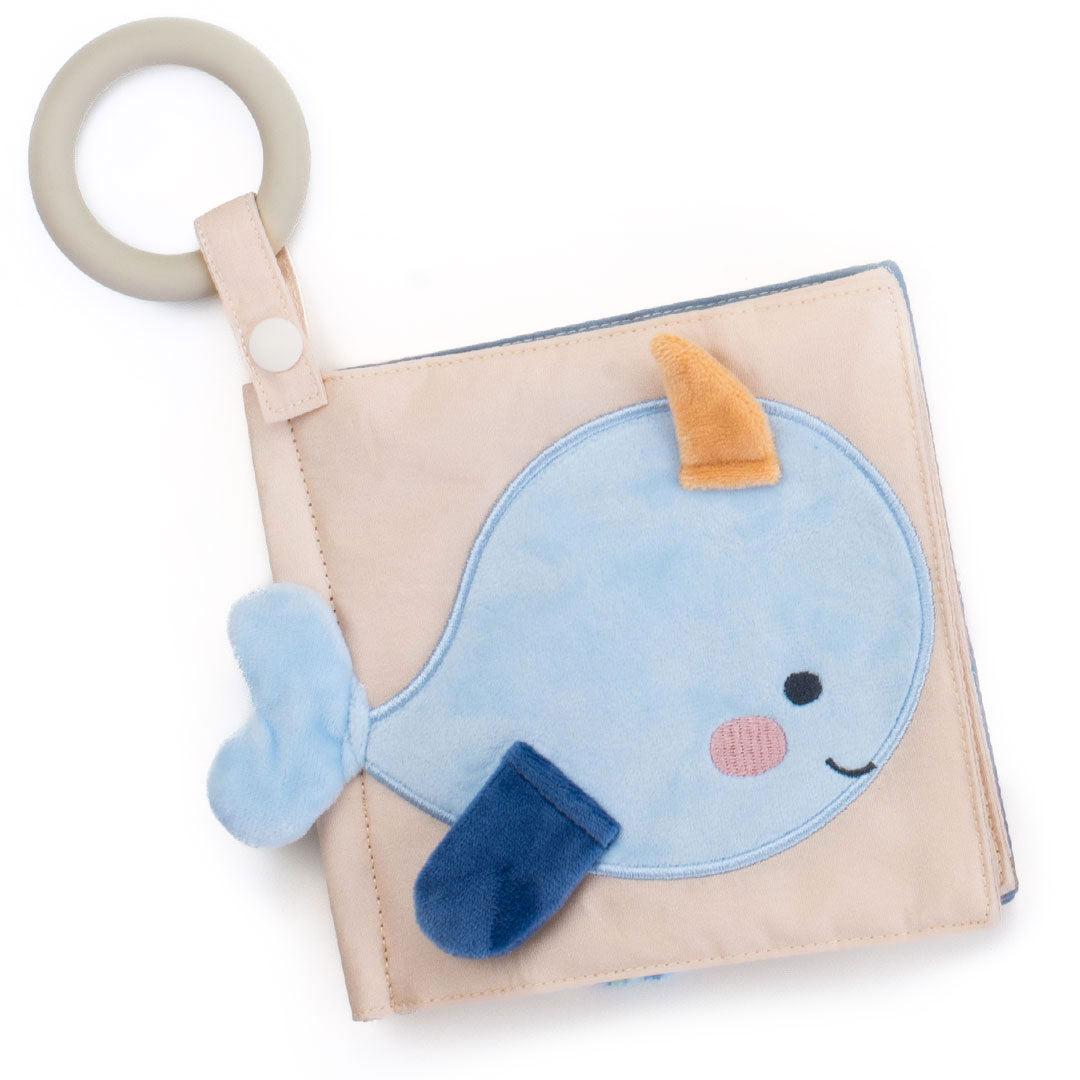 Baby soft sensory book with a blue whale design on a beige background