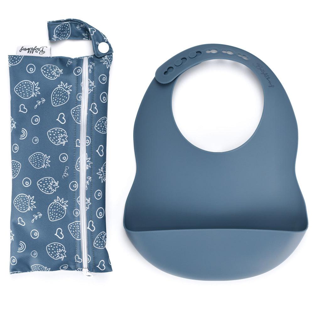 A deep blueberry-colored silicone pocket bib that can be rolled for storage, paired with its waterproof zippered carry bag complete with a handle, perfect for mealtimes on the go or eating out.