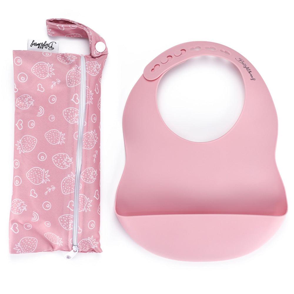 A vibrant coral-coloured silicone pocket bib showcased alongside its waterproof carry bag with a zipper, perfect for on the go meals.