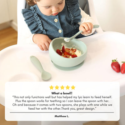 customer testimonial about Brightberry suction bowl set over the photo of a toidler girl feeding herslf from silicone bowl with silicone spoon