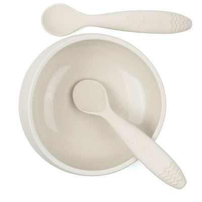 A sand-colored silicone suction bowl with two matching silicone spoons. The bowl has a strong suction base that keeps it in place during mealtime, even for active toddlers. The bowl is also designed with easy scooping curves to help babies feed themselves. The two spoons are soft and flexible, with sturdy handle & teething pattern on the handle  making them gentle on gums. The bowl and spoons are BPA-free and dishwasher safe. This product is designed in Australia.