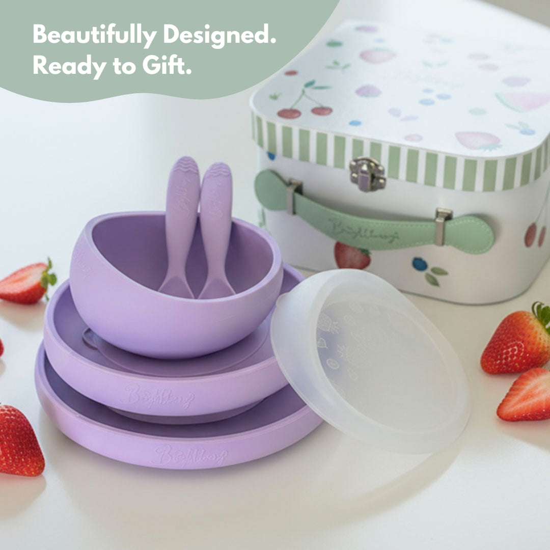 Purple children's tableware set with a gift box on a white background
