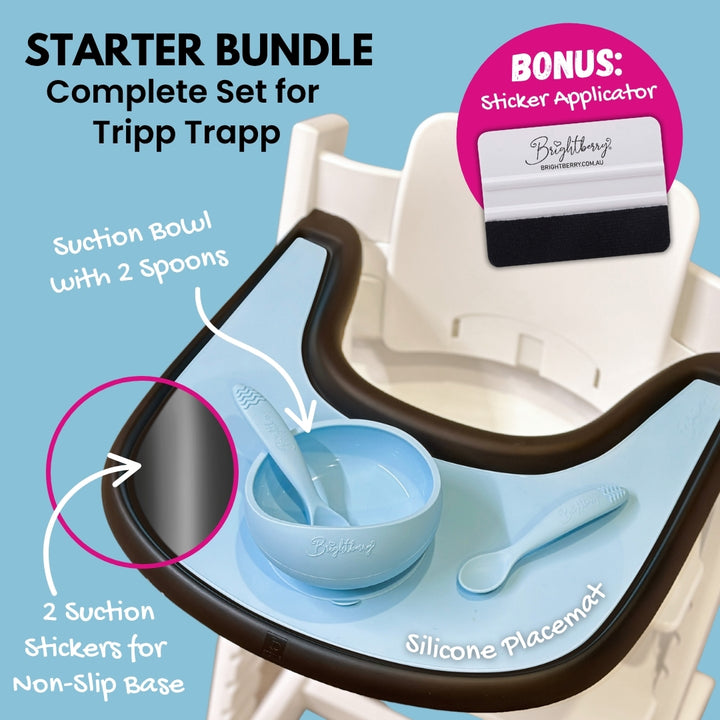 Brightberry Starter Bundle for Stokke Tripp Trapp featuring a suction bowl with two spoons, a silicone placemat, two suction stickers for a non-slip base, and a bonus sticker applicator, displayed on a high chair tray.