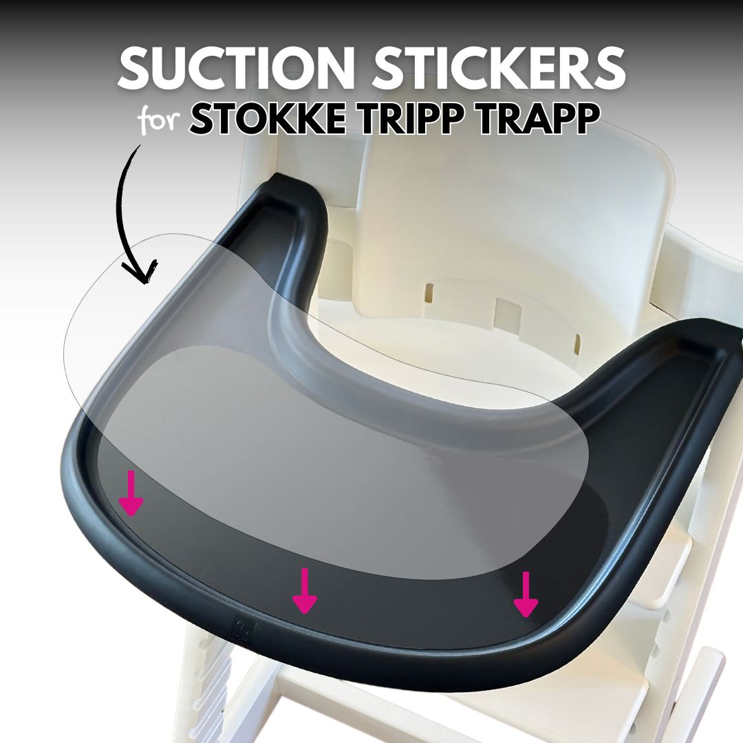 Stokke Tripp Trapp high chair with a black tray, featuring a suction sticker securely attached to the surface, designed to hold plates and bowls in place for mess-free mealtimes.